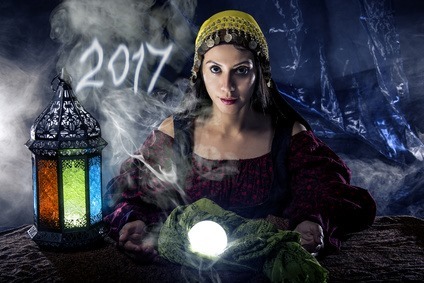 Female fortune teller doing a psychic reading with a cystal ball predicting the future of 2017.  The image is an illustrative editorial of the new year.